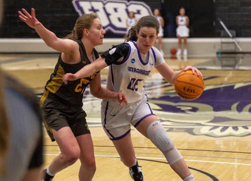 S-B-U female basketball player drives basketball to the hoop